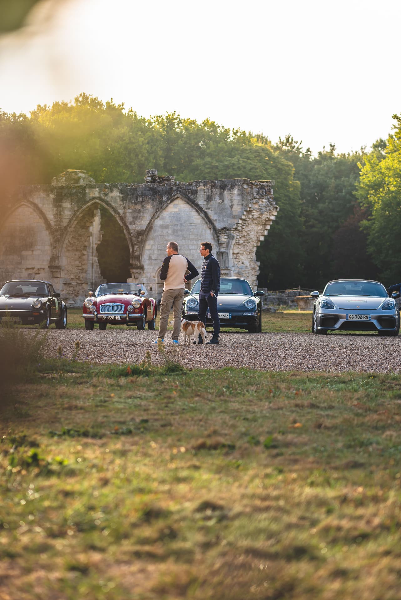 Automobiles et équipages près des ruines avant le départ