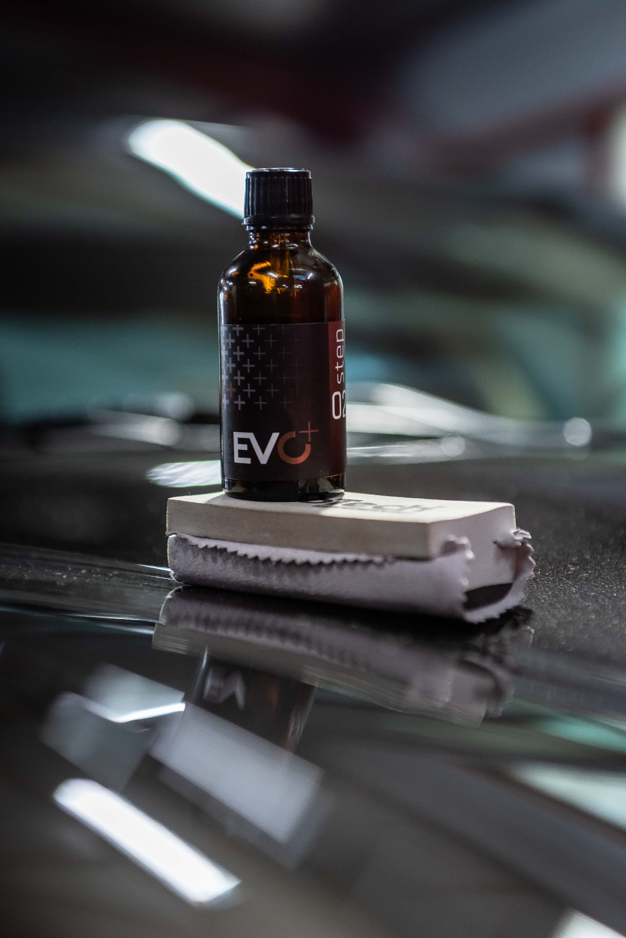 Flacon de traitement céramique EVO+ posé sur une carrosserie sombre